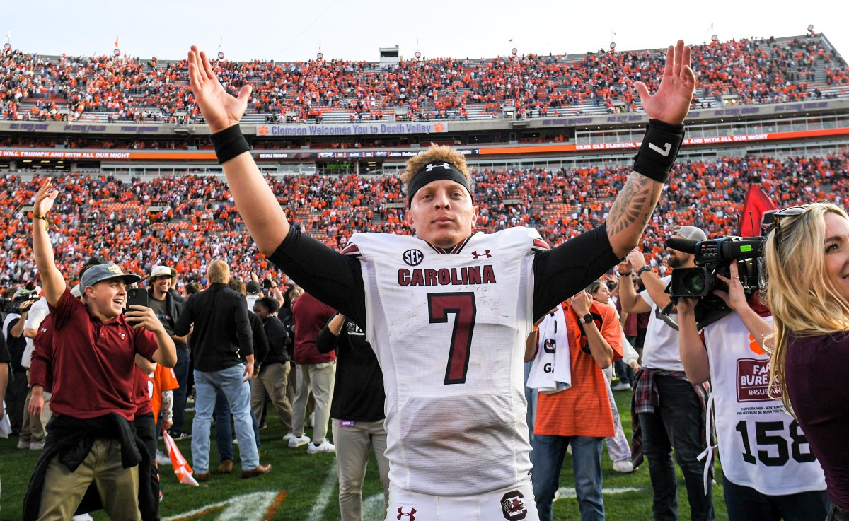 South Carolina quarterback Spencer Rattler raises his hands up in celebration